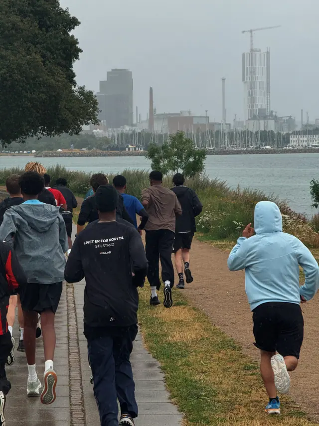 A group running along the waterfront