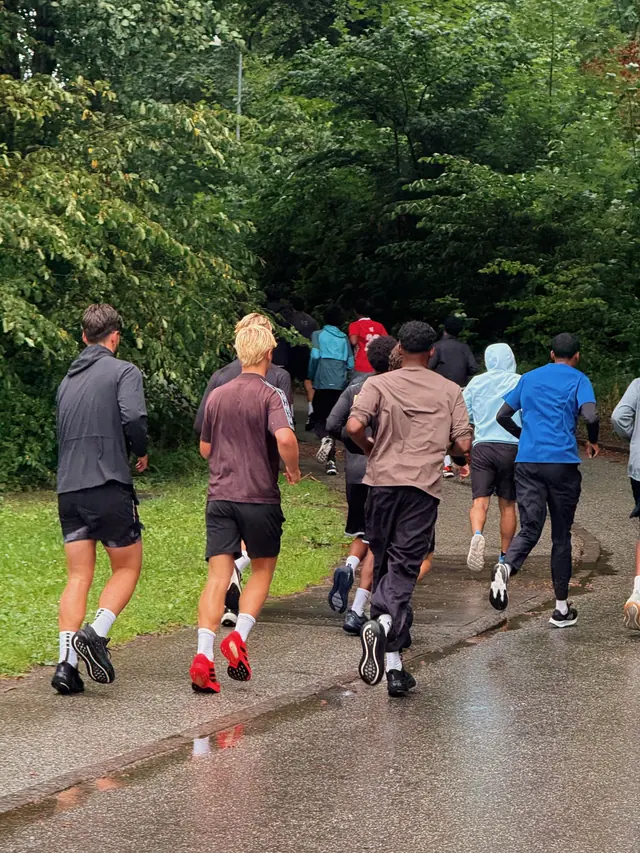 The group from behind in the rain