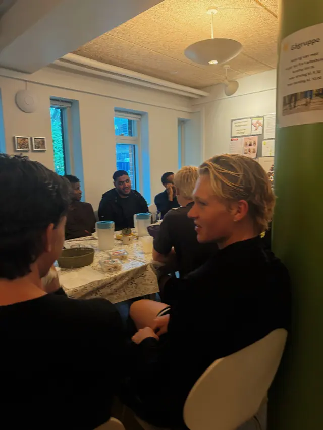 Conversation around a table indoors