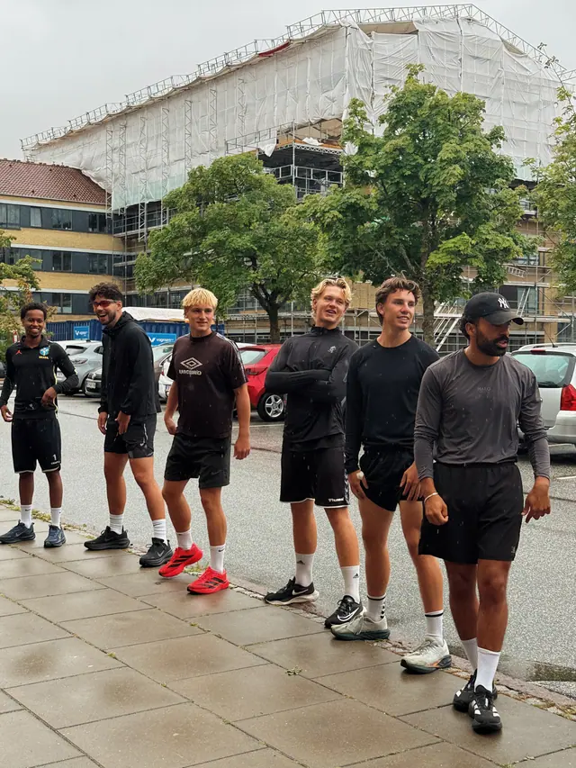 The group standing together on the pavement